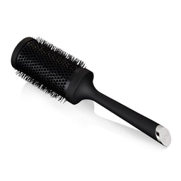 Black round hairbrush on a white background