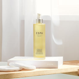 ESPA Optimal Skin Cleansing Oil on a wooden cabinet 