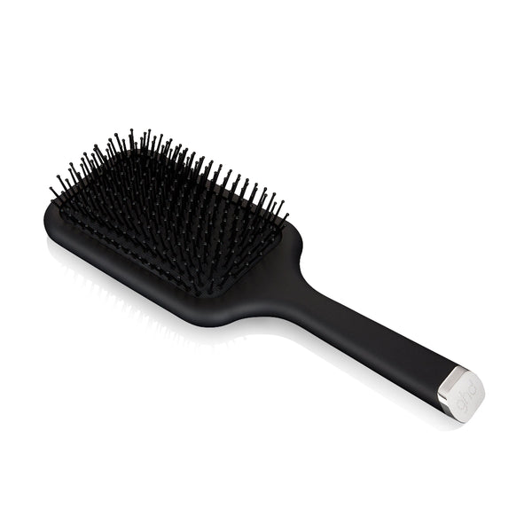 Black paddle hairbrush on a white background