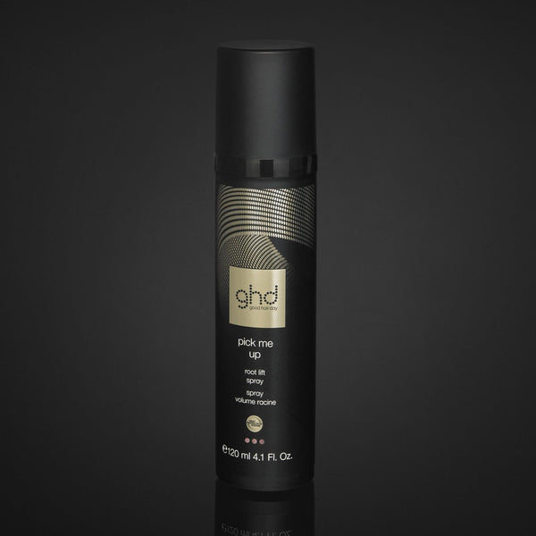 Black hair product bottle with gold text on a black background