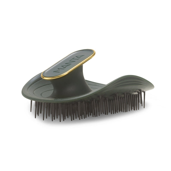 A Manta hairbrush with an olive green body, dark bristles, and a gold accent ring around the handle, shown on a white background.