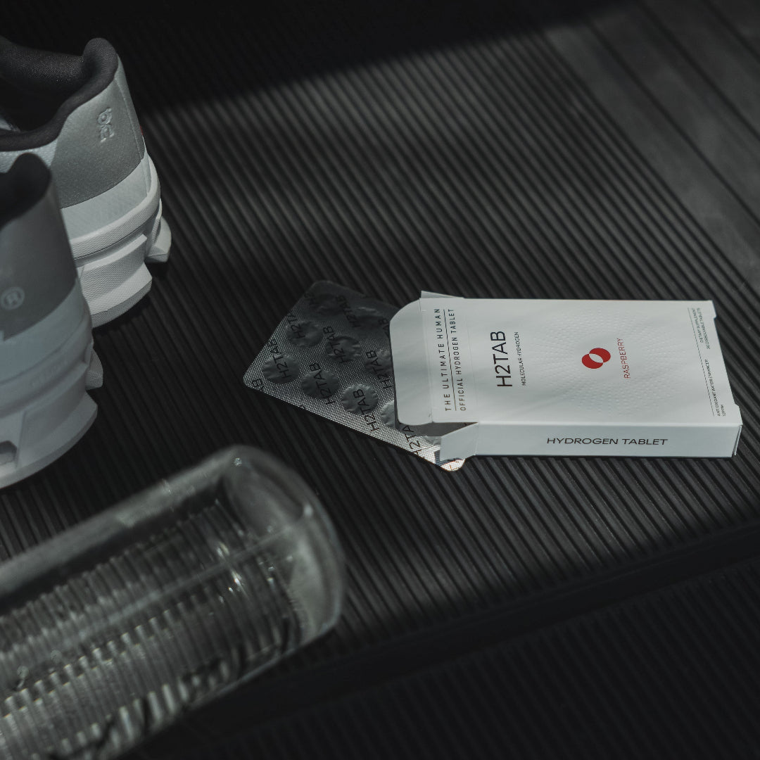 H2TAB hydrogen tablet packaging on a textured surface with a white container.