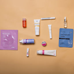 Collection of skincare products on a beige background