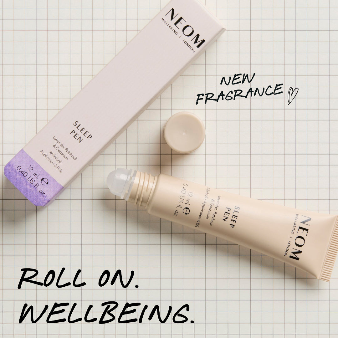 Neom Sleep Pen on a checkered background with text about new fragrance and roll-on wellbeing.