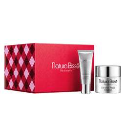 Natura Bissè Barcelona gift set featuring a red patterned box, a silver body lotion tube, and a silver cream jar on a white background.
