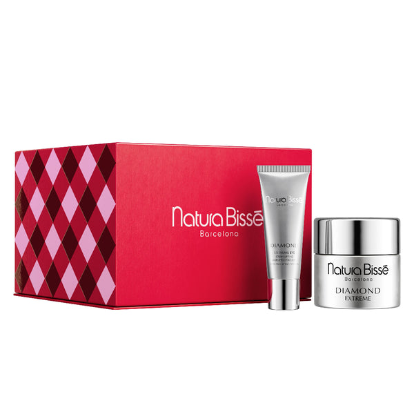 Natura Bissè Barcelona gift set featuring a red patterned box, a silver body lotion tube, and a silver cream jar on a white background.