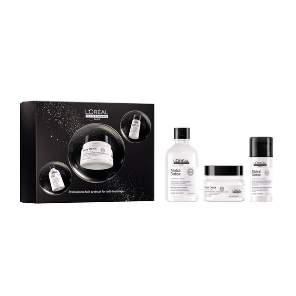 L'Oréal Professionnel Anti-Grève hair treatment set featuring a black gift box and three white bottles and jars with black caps: Scalp Care, Dandruff Care, and Hair Care.