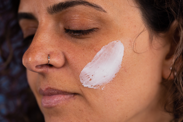 a closeup of a women with Proto-col Collagen Face Mask applied to her face