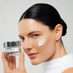 Woman holding a skincare product with a white background