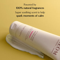 Hand and body balm bottle on a yellow background with text about natural fragrances.