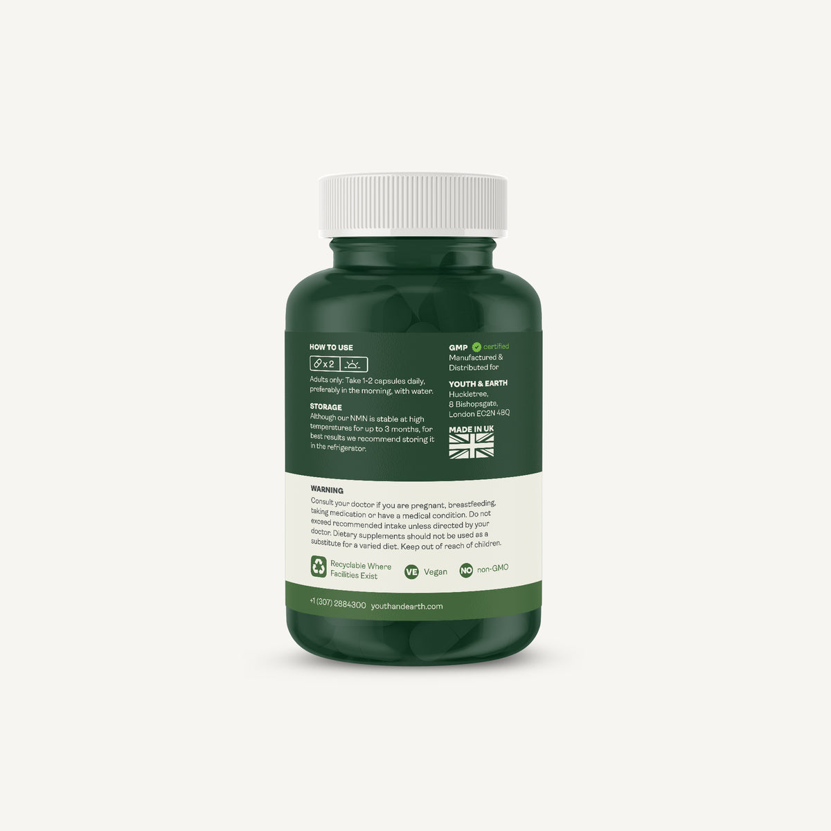 A dark green supplement bottle with a white cap, showing the back label with text and icons, set against a solid off-white background.