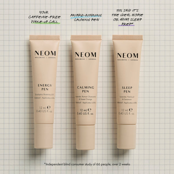 Three Neom energy, calming, and sleep pens on a grid background