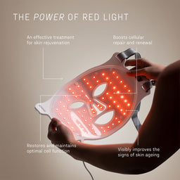 Red light therapy device held by a hand with text about its benefits on a beige background