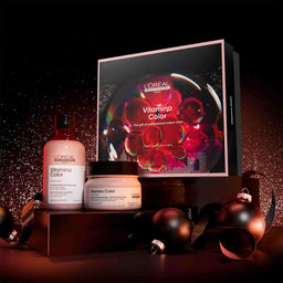 L'Oreal Vitamine Color hair care products with packaging on a dark background