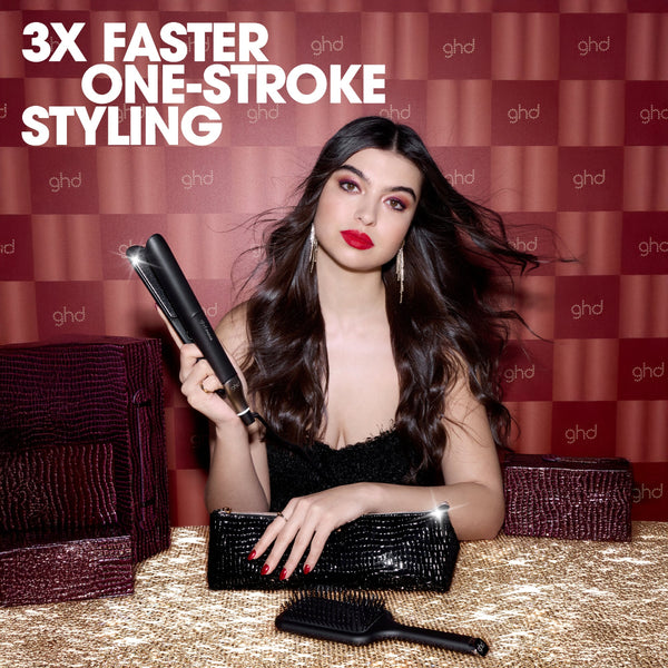 Woman holding a ghd styling tool with text '3X Faster One-Stroke Styling' against a branded background.