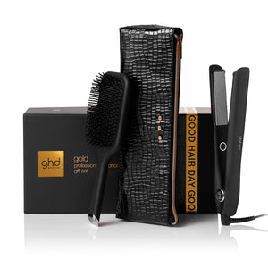 ghd hair care product set with brush, straightener, and box on a white background