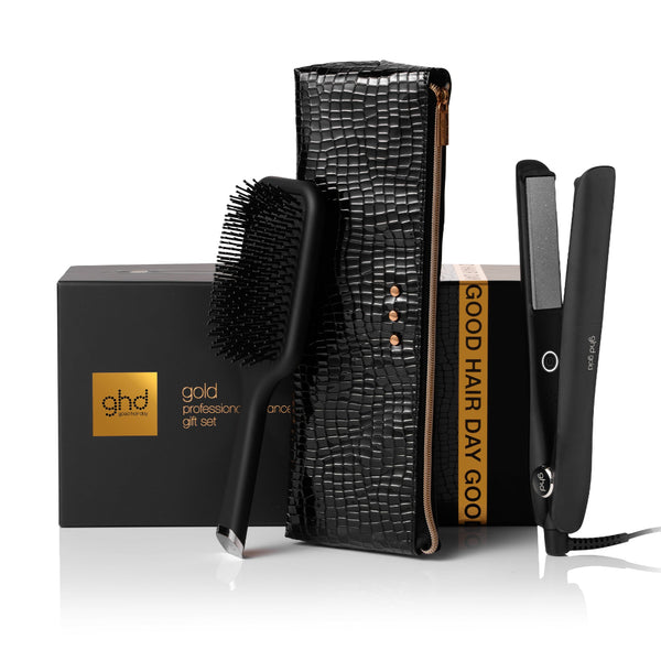 ghd hair care product set with brush, straightener, and box on a white background