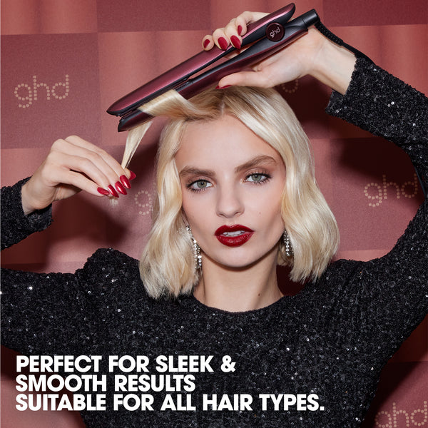 Woman using a ghd hair straightener with text about product features.