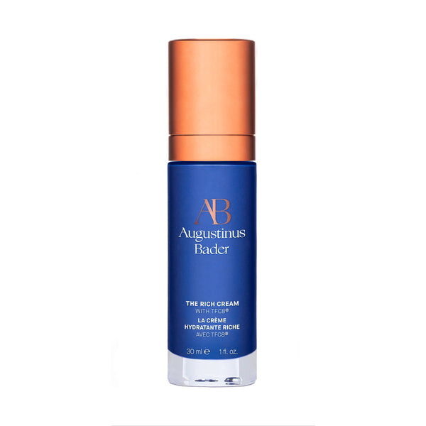 Blue skincare bottle with bronze cap on a white background