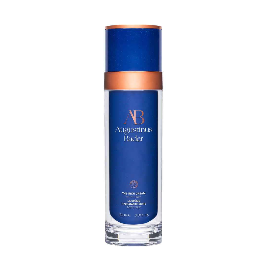 Blue skincare bottle with bronze cap on a white background