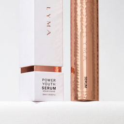LYMA Power Youth Serum shown with its white box and a metallic rose-gold cylindrical tube on a clean white background.
