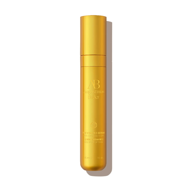 Gold cosmetic bottle with 'AB' branding on a white background