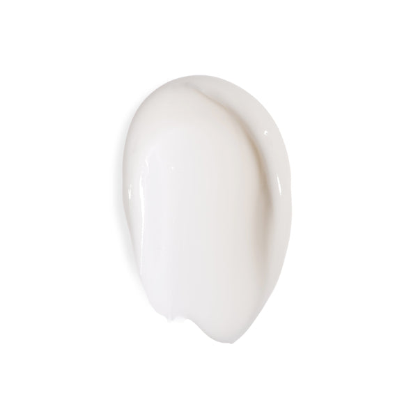 A smooth, glossy smear of off-white cosmetic cream or lotion on a solid white background.
