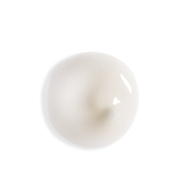 A glossy, smooth, off-white circular droplet or gel pool on a solid white background.
