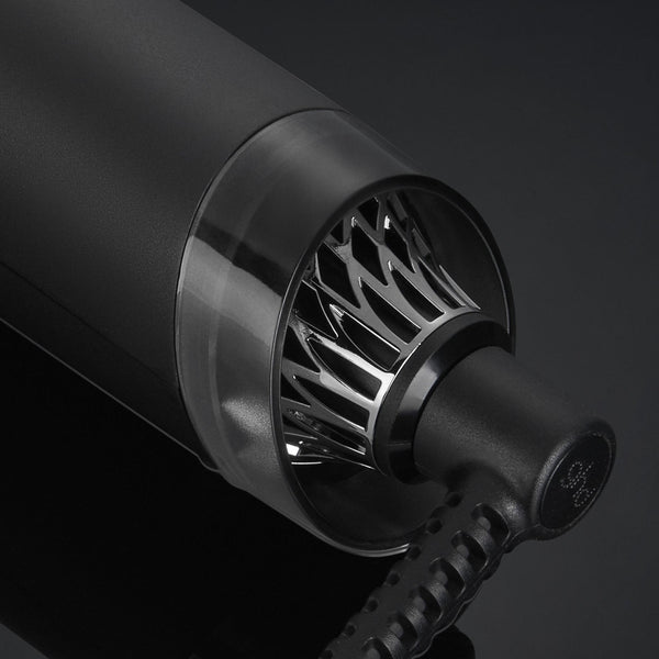 Close-up of a black hair dryer nozzle on a dark background