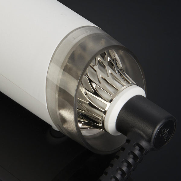Close-up of a cylindrical electronic device with metallic and white components on a black background