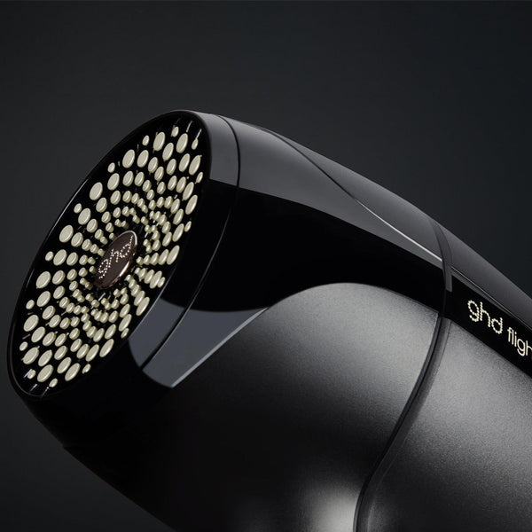 Black hair dryer with brand logo on a dark background