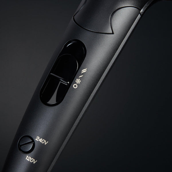 Black hair straightener with control buttons on a dark background