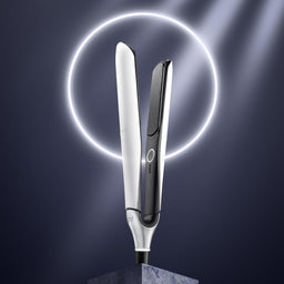 Hair straightener with a glowing circle on a dark background