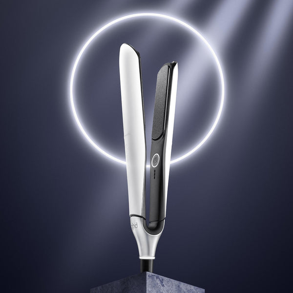 Hair straightener with a glowing circle on a dark background