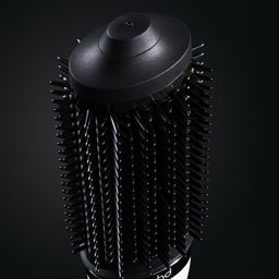 Black hair dryer brush on a black background