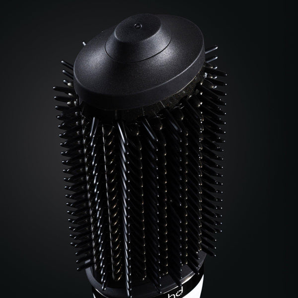 Black hair dryer brush on a black background
