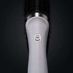 Gray hairbrush with bristle head on a black background