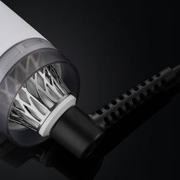 Close-up of a hair dryer with a black background