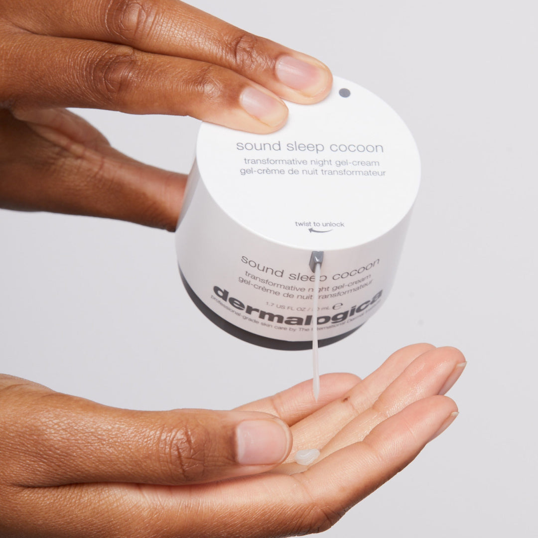 Dermalogica product being dispensed onto a hand against a neutral background