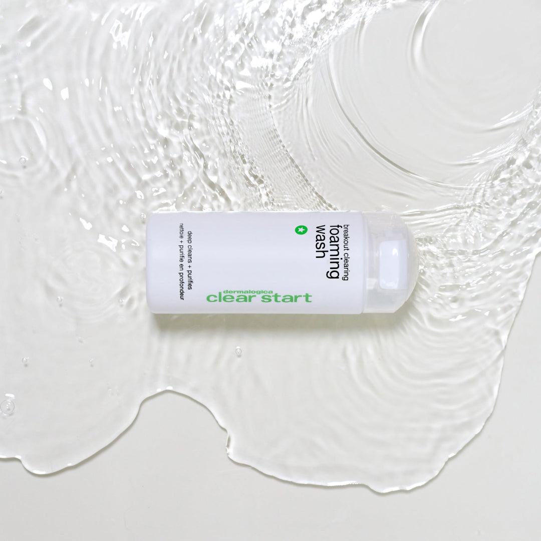 White skincare product bottle with text on a textured white background