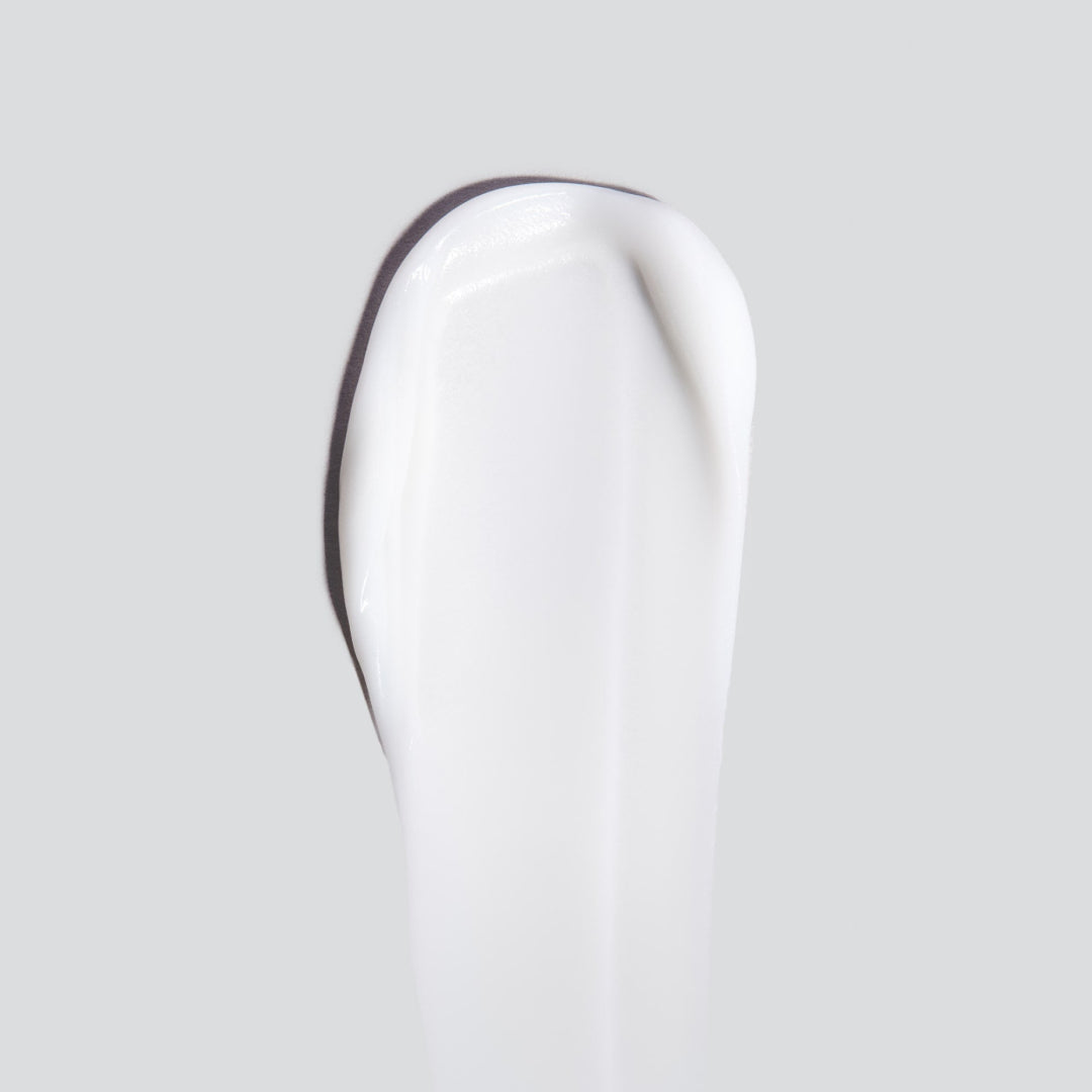 Close-up of a white ceramic tooth on a light gray background