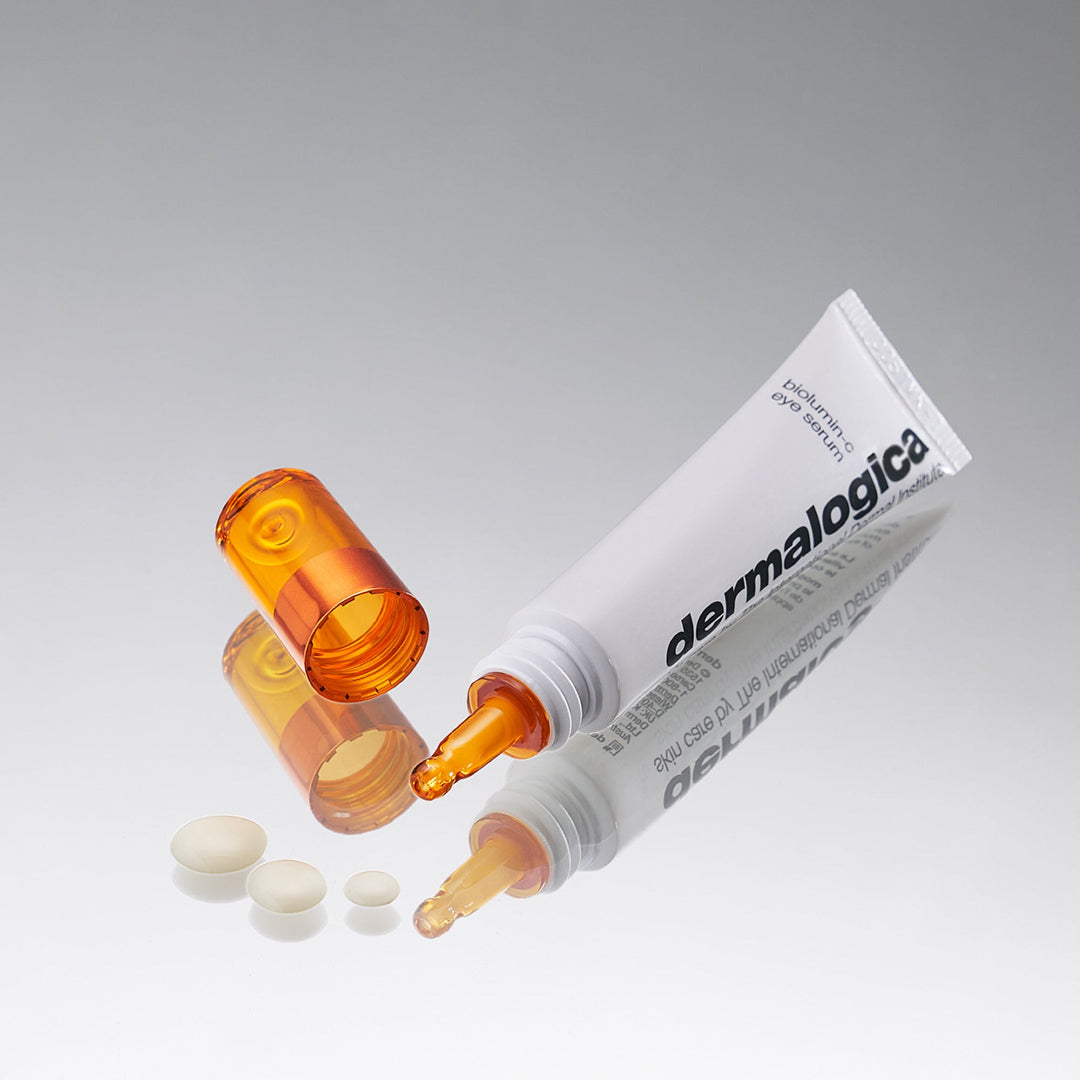 Dermalogica product with open cap and visible gel on a gray background