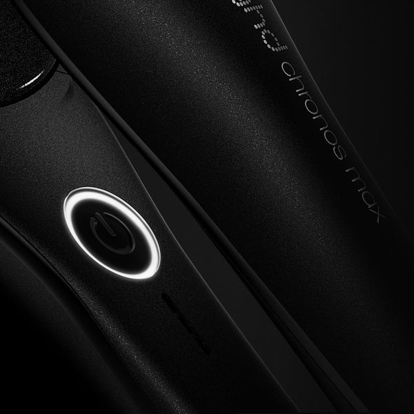 Close-up of a black electronic device with a circular component on a dark background