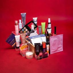Assorted beauty products on a red background