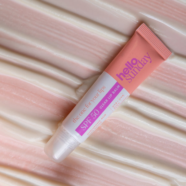 Tube of 'hello sunday' lip balm on a textured pink background