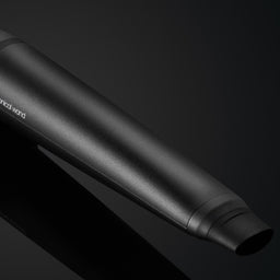 Black motorcycle exhaust on a dark background