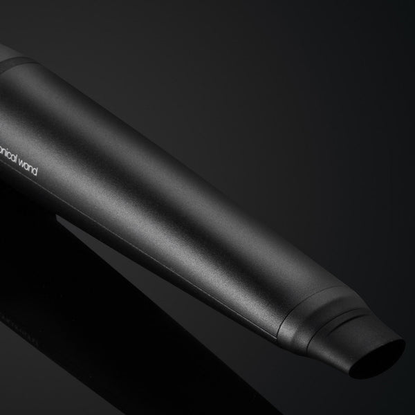 Black motorcycle exhaust on a dark background