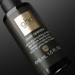 A bottle of ghd hair product labeled 'sleek operator' on a dark gradient background.