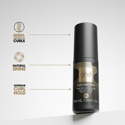 A bottle of ghd curl and shine hair oil stands on a white surface against a light gray background, with three callout graphics on the left highlighting high-elastic curls, natural shine, and superior curl hold.