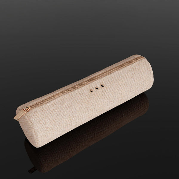 A slim, rectangular beige fabric pouch with a gold zipper and three small metallic button details, displayed on a reflective black surface.
